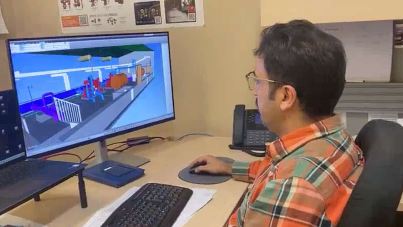 Engineer reviewing fire protection design on dual monitors